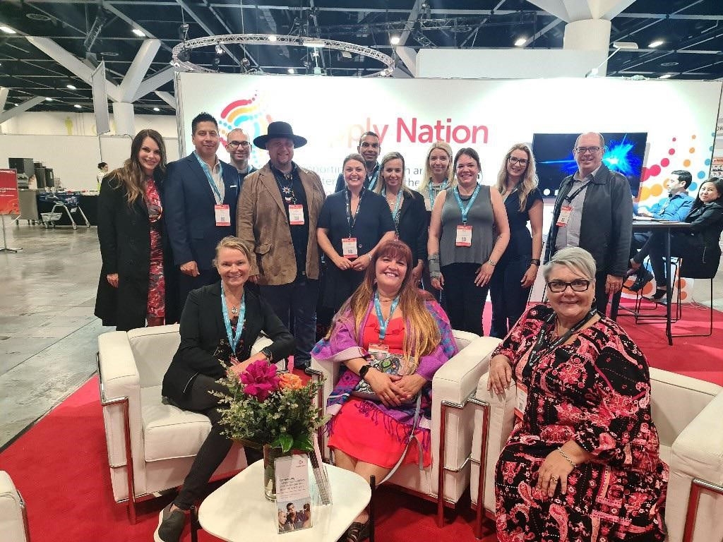 Group of people smiling and standing in front of a Supply Nation banner