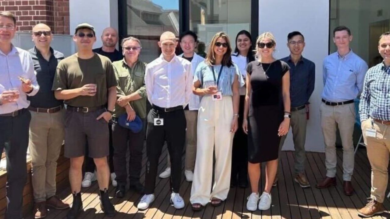 A group of men and woman standing on a patio who are members of the Trellis Technologies team in South Australia