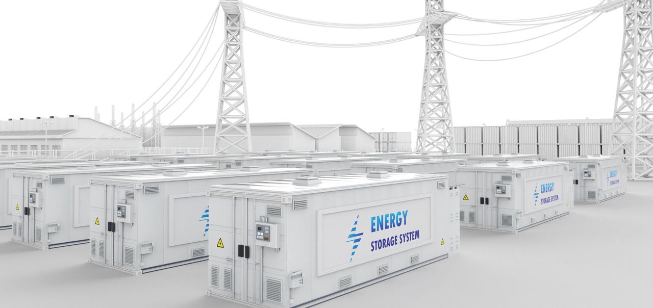 A number of big batteries in storage containers sit in front of high tension power transmission lines concept