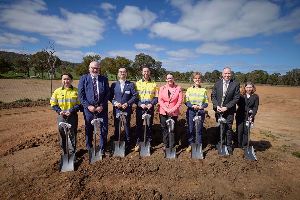 8 delegates holding shovels at an event at a gallium production plant