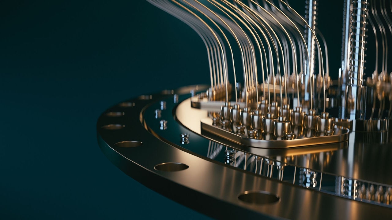 A closeup of a section of a quantum computer showing highly polished metal disks, tubes and connectors.