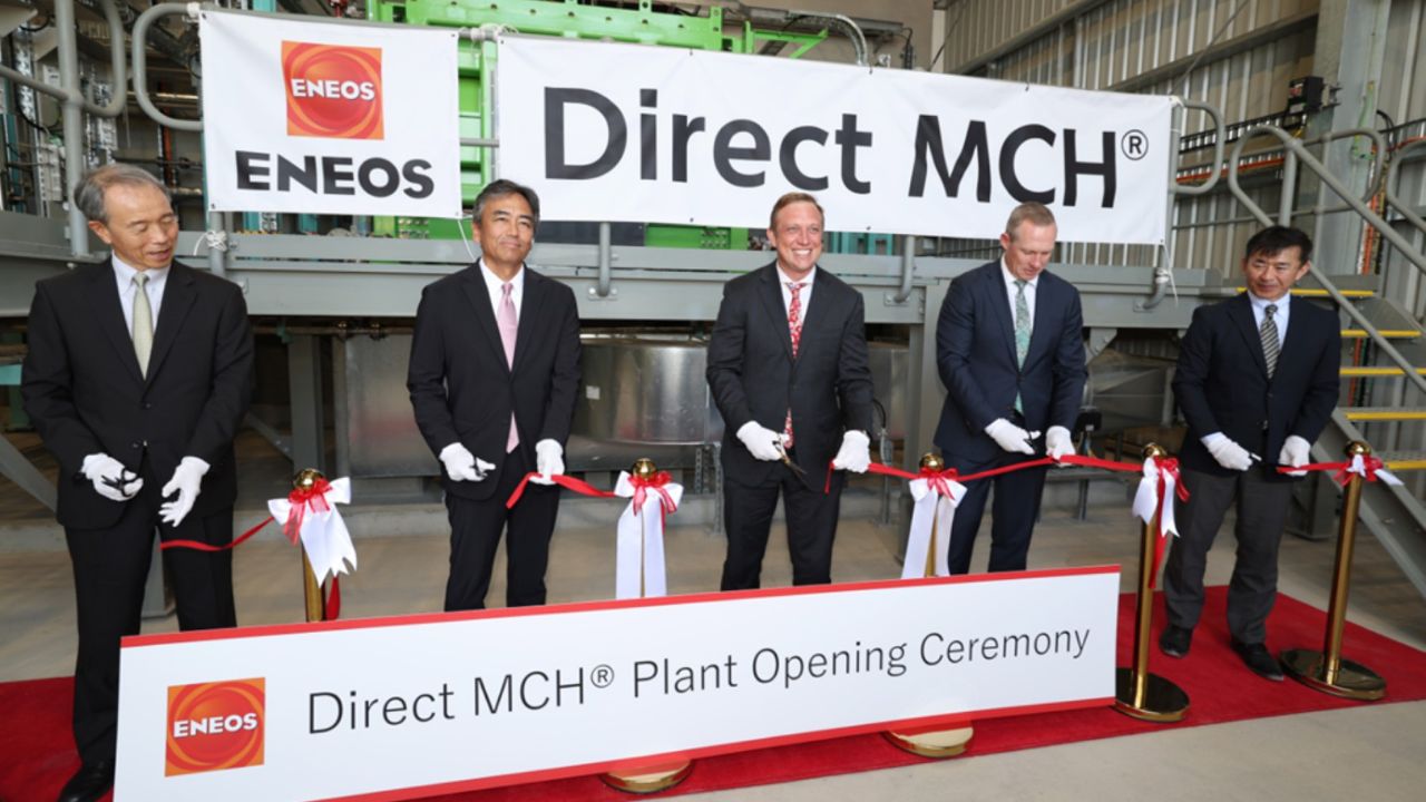 Five men in suits cutting a ribbon at the opening of ENEOS’ green hydrogen demonstration facility