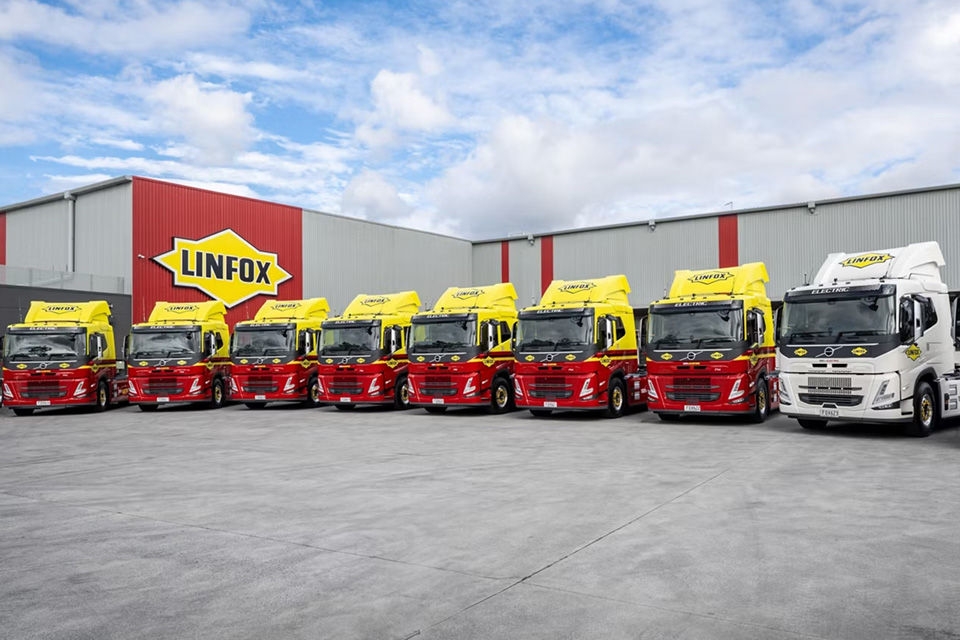 Volvo trucks lined up at a Linfox facility.