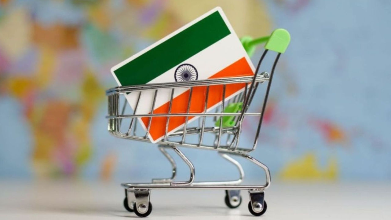 An Indian national flag in miniature shopping trolley with a world map in the background