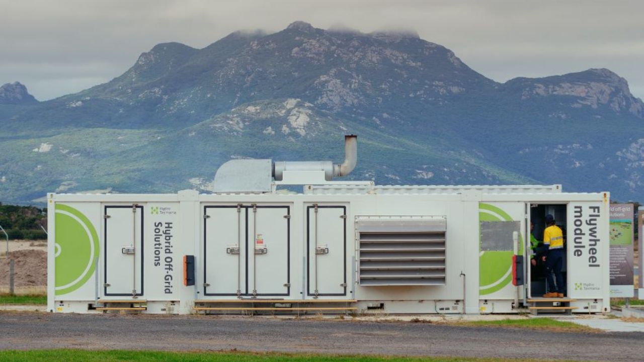 A number of rectangular metal containers are connected to house a mobile clean energy distribution system